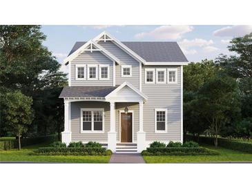 Two-story craftsman style home with gray siding, white trim, and landscaping at 744 47Th N Ave, St Petersburg, FL 33703