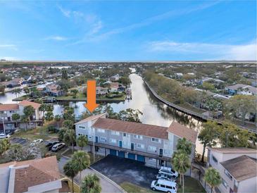 Condo building near a waterway; showcasing the surrounding landscape at 6311 Newtown Cir # 11B1, Tampa, FL 33615