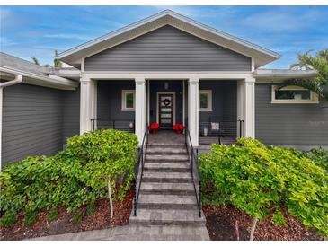 Gray house with a white door and large front porch at 930 Monterey Ne Pt, St Petersburg, FL 33704