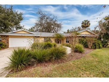 House exterior features a two-car garage and nicely landscaped lawn at 531 Garrard Dr, Temple Terrace, FL 33617