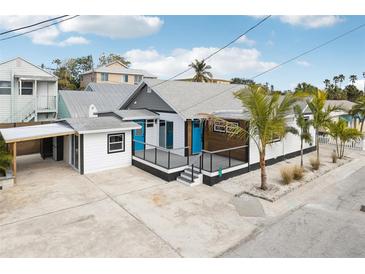 Newly renovated home with a modern deck, carport, and tropical landscaping at 126 90Th Ave, Treasure Island, FL 33706