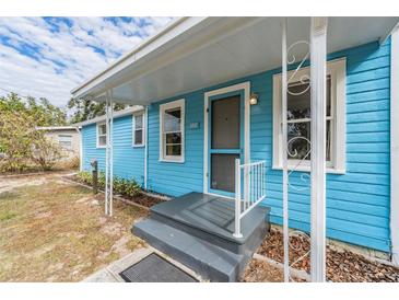Light blue house with a front porch and landscaped yard at 1841 Overbrook Ave, Clearwater, FL 33755