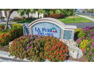 La Puerta Del Sol community entrance with landscaping at 5633 Puerta Del Sol S Blvd # 203, St Petersburg, FL 33715