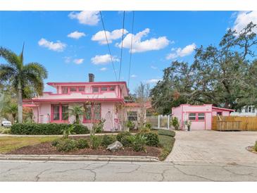 Pink house with a long driveway and guest house at 700 S Prospect Ave, Clearwater, FL 33756