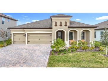 Two-story home with attractive landscaping and a two-car garage at 13028 Homestead Ln, Parrish, FL 34219