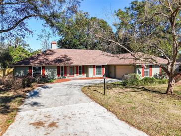 Ranch-style home with red shutters and a spacious driveway at 2712 Mock Orange Ct, Valrico, FL 33594