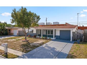 Inviting single story home featuring a landscaped yard and attached garage at 3421 Cantrell St, Holiday, FL 34690