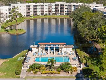 Community pool with surrounding patio and lounge chairs at 5705 80Th St N # 304, St Petersburg, FL 33709