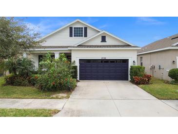Single-story house with a two-car garage and landscaped front yard at 5725 Stockport St, Riverview, FL 33578