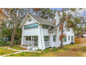 Charming craftsman style home features a renovated exterior, front porch, and landscaping at 718 34Th S Ave, St Petersburg, FL 33705