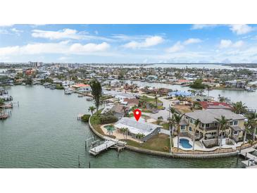 Waterfront property with backyard pool, dock, lush landscaping, and scenic water views at 7800 3Rd S Ave, St Petersburg, FL 33707