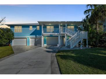 Two-story waterfront home with a two-car garage and a large deck at 2601 Bay Blvd, Indian Rocks Beach, FL 33785