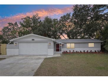 Charming single story home with gray exterior and two-car garage at 11592 110Th Ter, Seminole, FL 33778