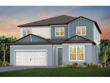 Two-story home with blue and white siding, brown roof, and a two-car garage at 12652 Glenn Creek Dr, Riverview, FL 33569