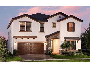 Two-story house with brown accents and a large wooden garage door at 14814 Paddock Pond Ave, Lithia, FL 33547