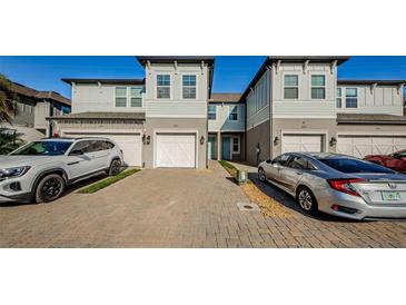 Two-story townhome with white garage doors and light gray siding at 1621 Eagle Creek Dr, Clearwater, FL 33764