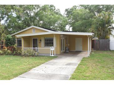 Cute yellow house with carport and a fenced backyard at 619 Glenoak N St, St Petersburg, FL 33703