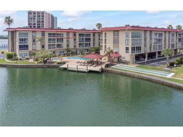 Aerial view of condo building, pool, and marina at 105 Island Way # 146, Clearwater, FL 33767
