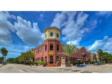 Brick building with Metro Market on the ground floor and apartments above at 2010 E Palm Ave # 15305, Tampa, FL 33605