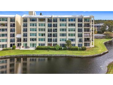 Condo building exterior with water view and lush landscaping at 225 Country Club Dr # 1611, Largo, FL 33771