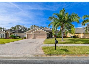 Beautiful two-story home with a three-car garage and a nicely landscaped lawn at 3407 Walden Reserve Dr, Plant City, FL 33566