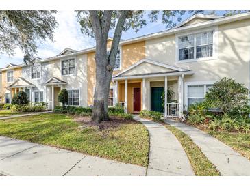 Two-story townhome with a green door and walkway at 3529 High Hampton Cir, Tampa, FL 33610
