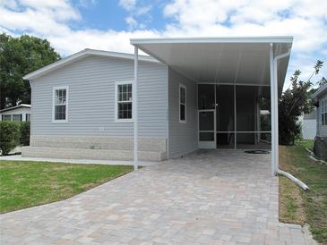 Gray mobile home with covered carport and paved driveway at 3722 Spinnaker Dr, Tampa, FL 33611