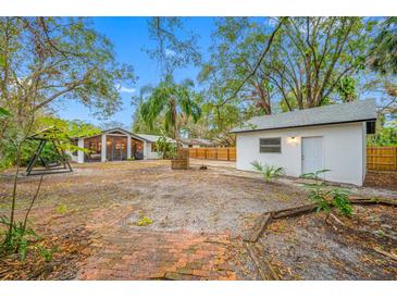 Large backyard with detached garage, fire pit and patio at 505 Jefferson S Ave, Oldsmar, FL 34677