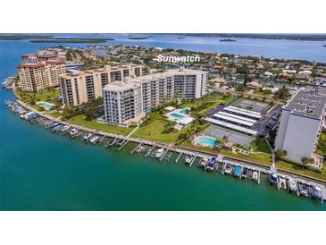 Aerial view of Sunwatch, a waterfront community with tennis courts, pool, and boat slips at 670 Island Way # 500, Clearwater Beach, FL 33767