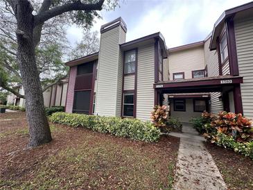 Exterior view of condo building, showing landscaping and building features at 1568 Nantucket Ct # 1302, Palm Harbor, FL 34683