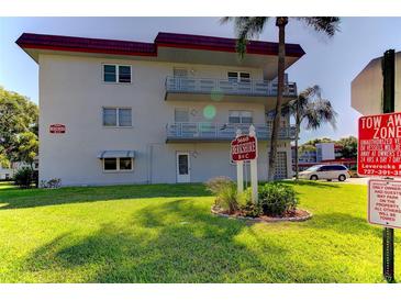 Building exterior showcasing landscaping and parking at 5660 80Th N St # C307, St Petersburg, FL 33709