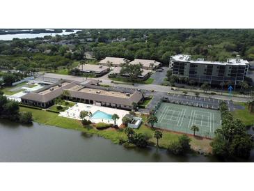 Aerial view of condo community with pool, tennis courts, and waterfront access at 9860 62Nd N Ter # 1013, St Petersburg, FL 33708