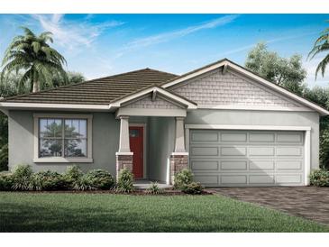 One-story home with gray siding, red door, and two-car garage at 12269 New Tranquility Path, Venice, FL 34293