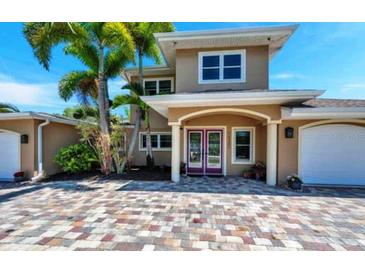 Two-story home with double doors and a brick driveway at 16301 Redington Dr, Redington Beach, FL 33708
