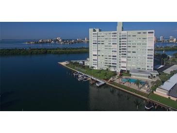 Aerial view of waterfront highrise building with pool and boat slips at 31 Island Way # 303, Clearwater Beach, FL 33767