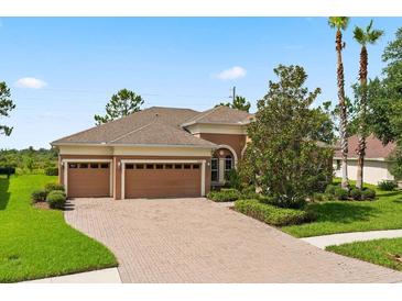 Attractive single-story home with a two-car garage and manicured lawn at 32202 Summerglade Dr, Wesley Chapel, FL 33545