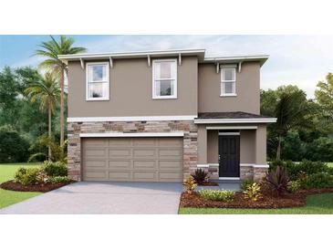 Two-story house with stone accents and a two-car garage at 6995 Broad River Ave, Land O Lakes, FL 34638