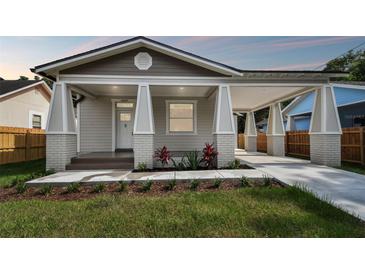 Newly constructed craftsman style home with covered porch and landscaped yard at 1309 E Cayuga N St, Tampa, FL 33603