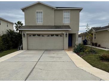 Two-story house with attached garage and well-maintained landscaping at 17346 Mint Leaf Ln, Land O Lakes, FL 34638