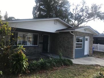 Charming single story home with stone facade and a well-maintained lawn at 1766 Montana Ne Ave, St Petersburg, FL 33703