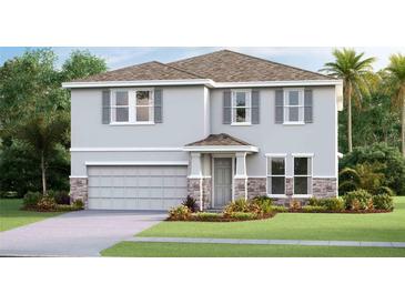 Two-story house with gray siding, stone accents, and a two-car garage at 6724 Broad River Ave, Land O Lakes, FL 34638