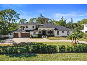 Stunning two-story home with a three-car garage and manicured lawn at 9050 San Martin Ne Blvd, St Petersburg, FL 33702