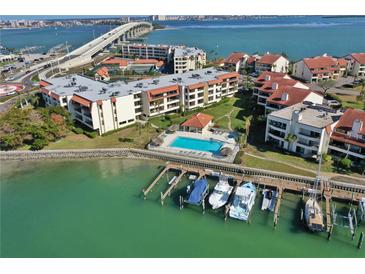 Aerial view of waterfront community with pool, boat slips, and lush landscaping at 106 1St E St # 115, St Petersburg, FL 33715