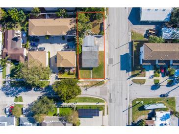 Aerial view of a single-Gathering home with a yard, located in a residential neighborhood at 312 S Arrawana Ave, Tampa, FL 33609