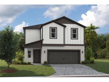 Two-story house with dark brown accents and a two-car garage at 37306 Sagemoor Dr, Zephyrhills, FL 33541