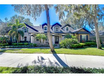 Stunning two-story home with manicured landscaping and a large driveway at 17838 Mission Oak Dr, Lithia, FL 33547