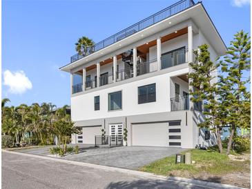Stunning modern home with three-car garage and multiple balconies at 18077 3Rd St, Redington Shores, FL 33708