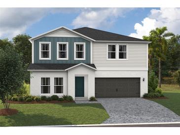 Two-story home with gray and blue siding, dark garage door, and landscaping at 2049 Stillview Pass, Zephyrhills, FL 33541