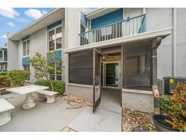 Private patio with table and bench, screened porch access at 380 Medallion Blvd # B, Madeira Beach, FL 33708