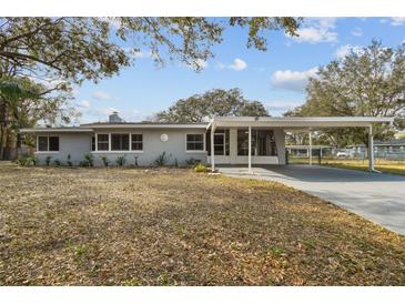 Exterior view of a single story house with carport and lawn at 10308 Forest Hills Dr, Tampa, FL 33612
